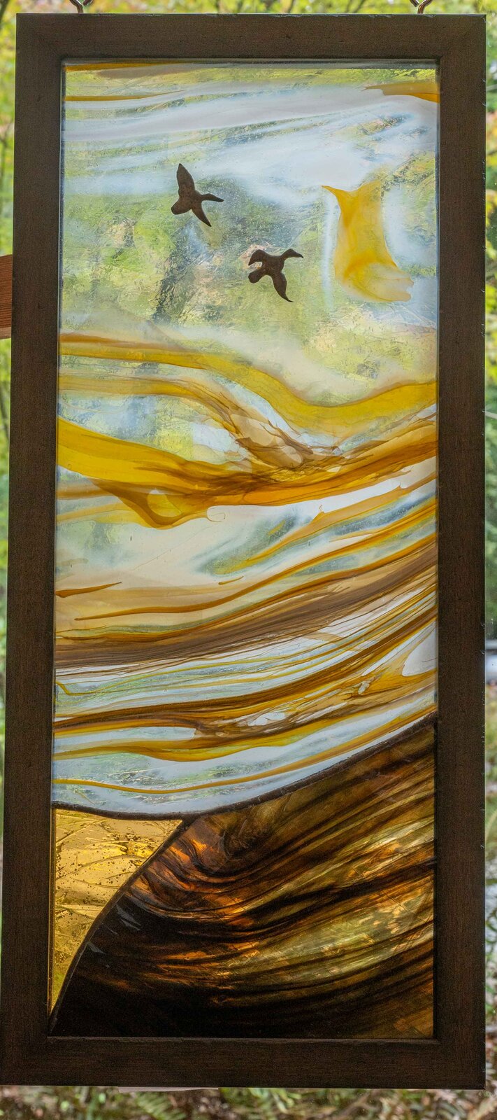 Sunset Migration, an amber streaky glass panel with two birds in flight over a golden landscape