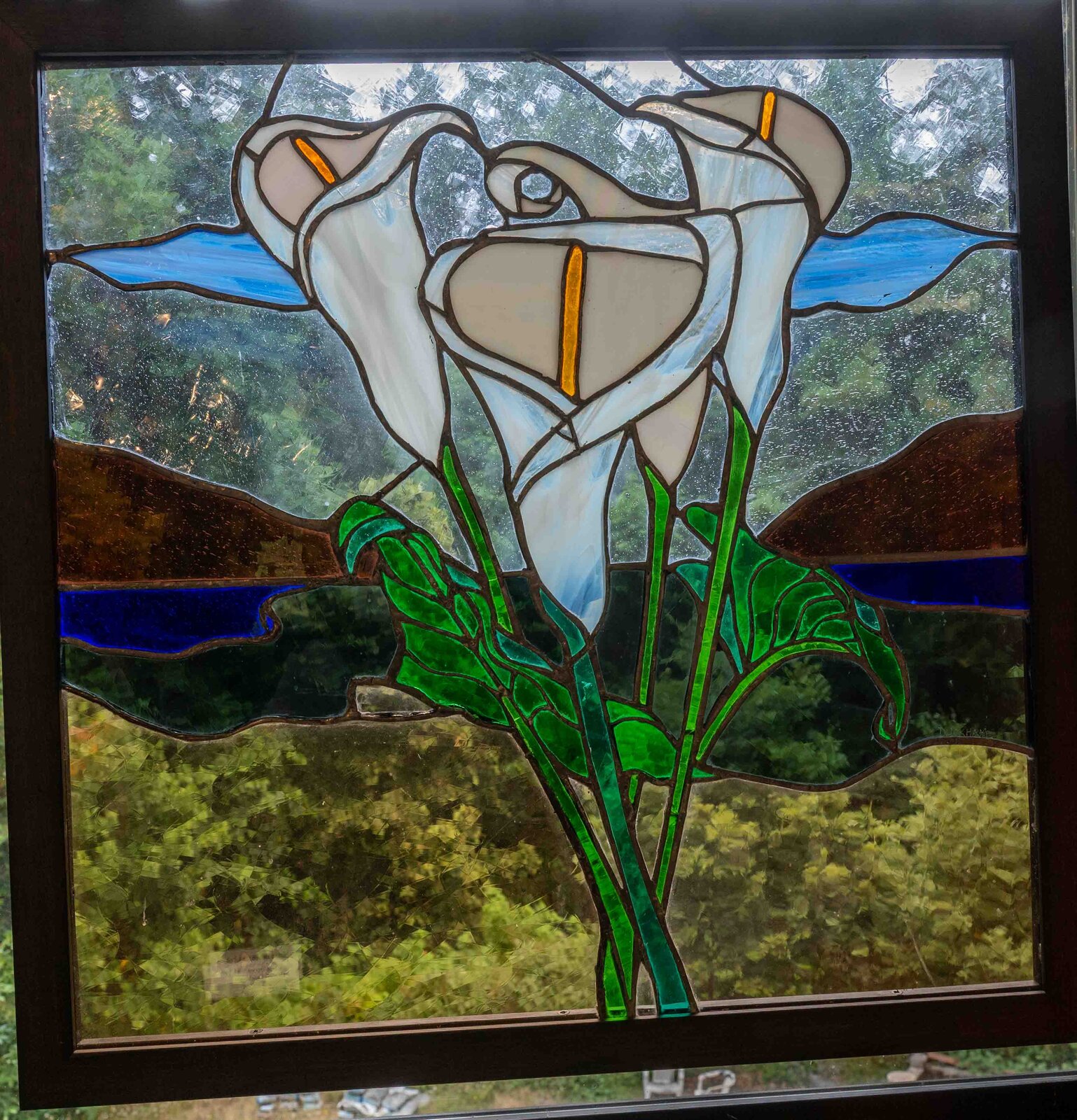 Calla Grace, a stained glass panel of calla lilies over a mountain landscape