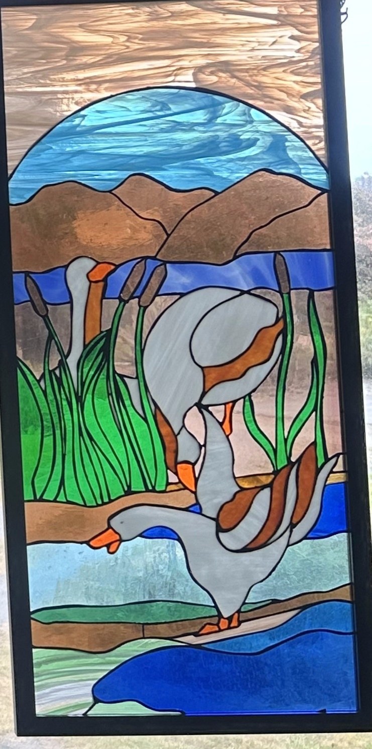 Stained glass window of geese in a marsh, right panel