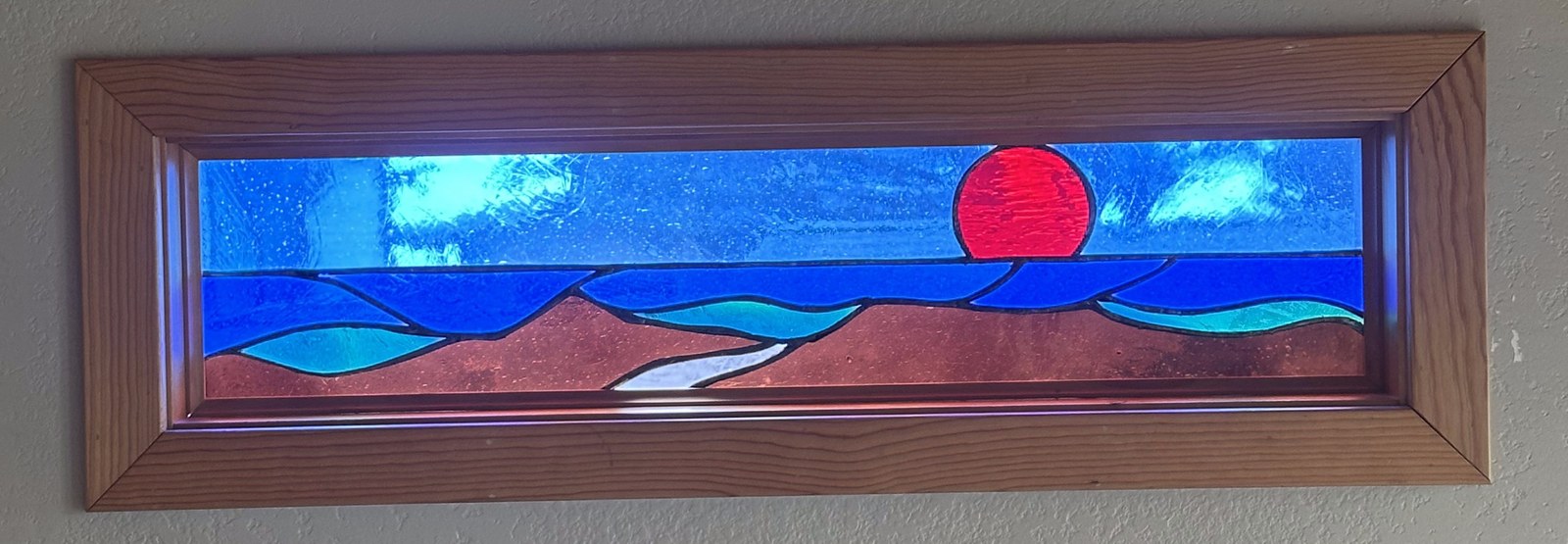 Stained glass transom window of mountains and sunset