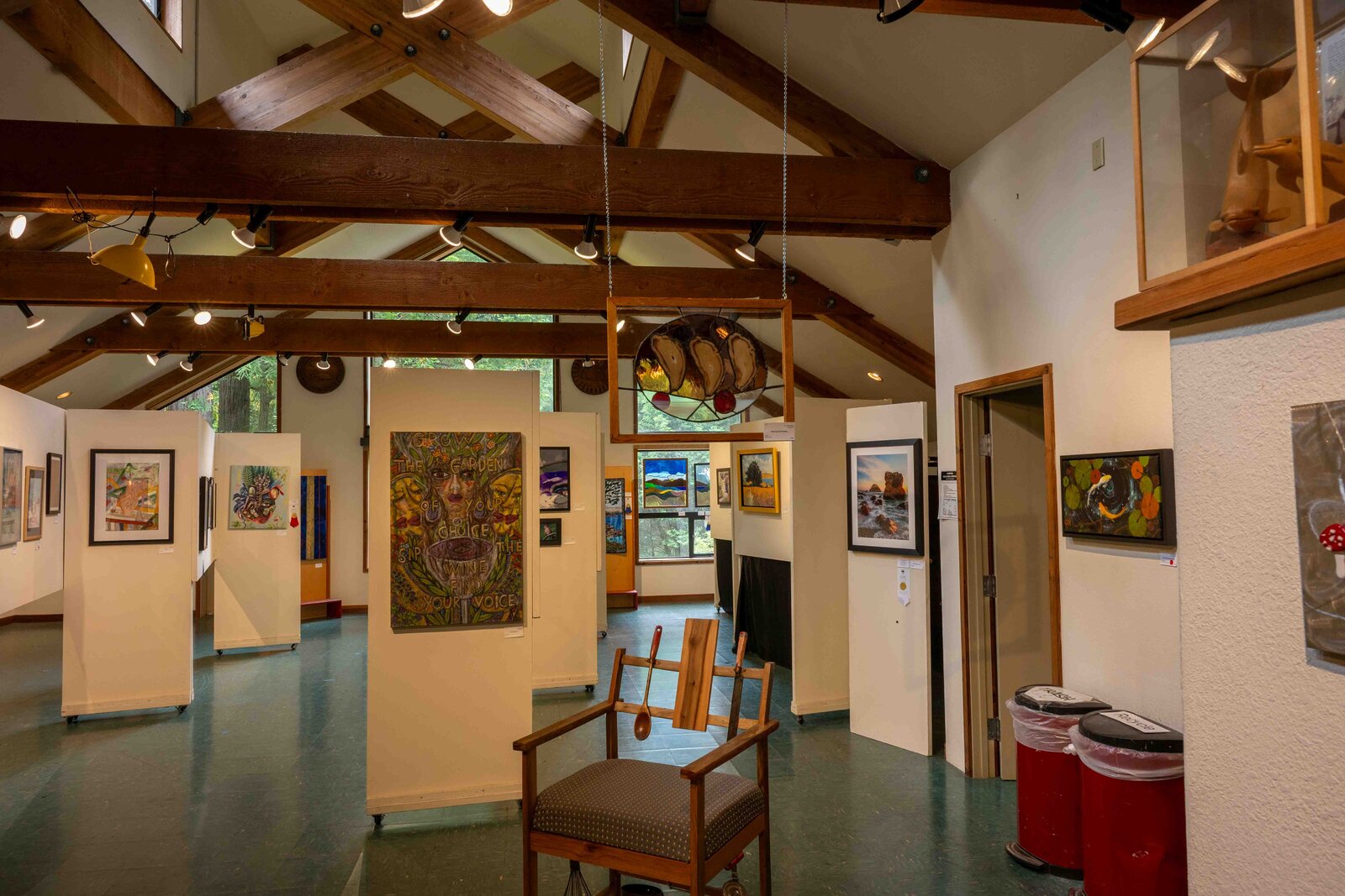 Dancing Pork Chops hanging at the Gualala Arts Center, with other Art in the Redwoods entries in the background