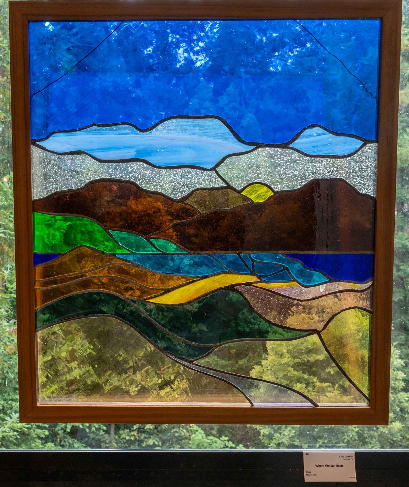 Where the Sun Rests, a layered stained glass landscape of hills and sea